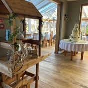 A "Just Married" sweet cart and wedding cake in the conservatory