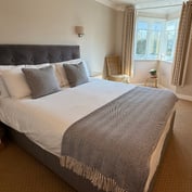 Double room — close view of the bed and bay window