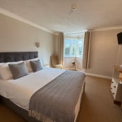 Double room with king-size bed, bay window, dressing table and TV
