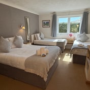 Family room — wider angle showing the double bed and two singles