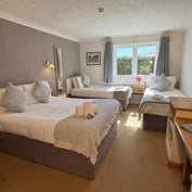 Family room with double bed and a single bed, window onto the garden