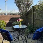 Bistro table with tulips on the garden room's private sun-trap patio