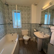 River-view room en-suite with bath, shower above and basin