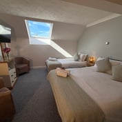 Loft-room triple with skylight, single and double beds, TV and an armchair