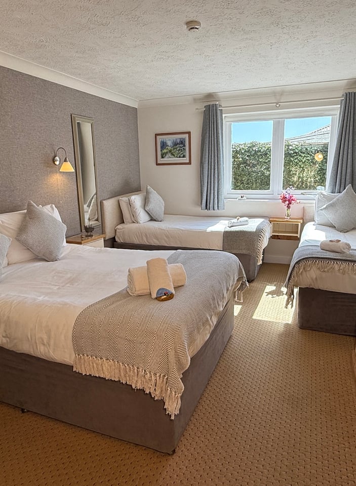 Family room with double bed and a single bed, window onto the garden